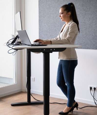 A standing desk or a sit stand desk to help you alternate between sitting and standing throughout the day
