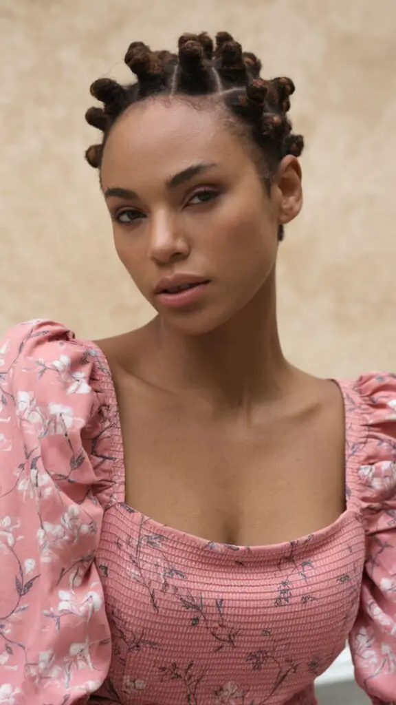 Short hair styled with tight coils, showcasing bold character and texture. This eye-catching look features well-defined curls achieved with a small curling iron or flexi rods, creating a lively and vibrant hairstyle. Perfect for a confident, standout appearance, these curls are maintained with regular moisturizing and leave-in conditioner for healthy, bouncy results.